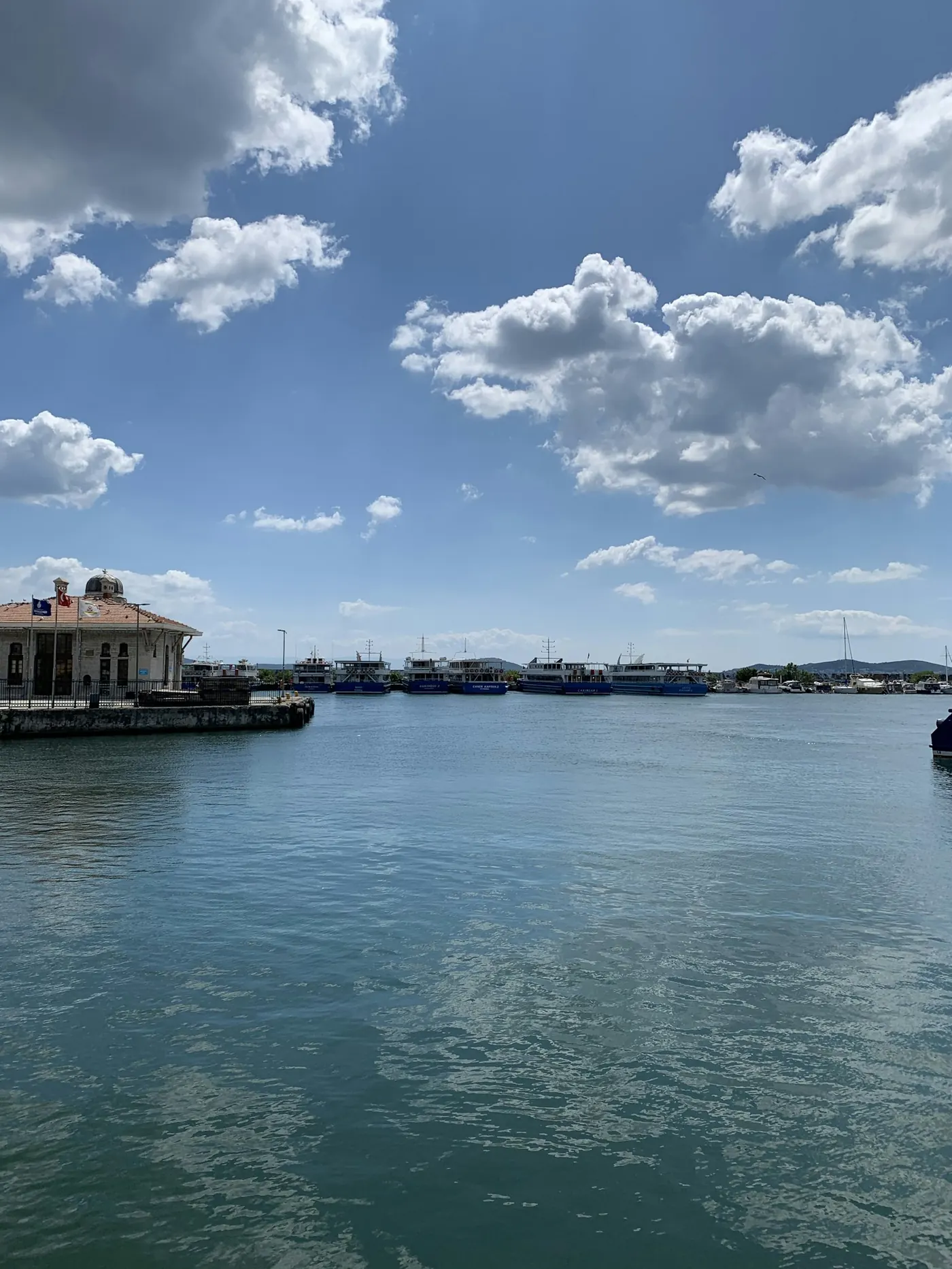 Historic waterfront building on the Kadıköy shoreline under a blue sky